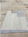 Honed surface finish checking on beige travertine window sill